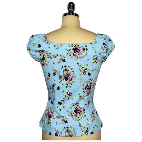 Siren Clothing 50's vintage-inspired top with elasticated short sleeves and front pleat detail in blue floral cotton spandex fabric, back view