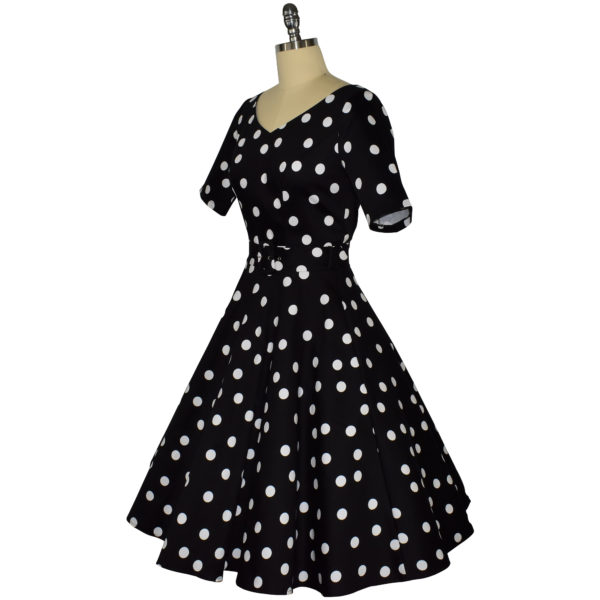 Siren Clothing 50's vintage-inspired swing dress with sleeves in black and white polka dot fabric, side view